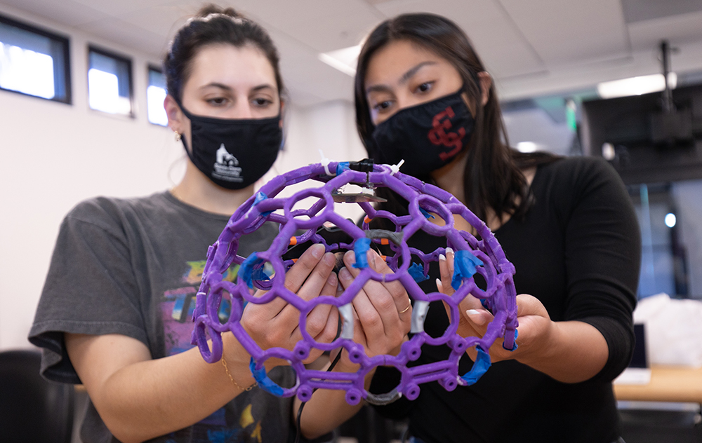ngineering students Louise Mantilla '22, left, and Michelle Wong '22, are part of a team designing a prototype that stimulates the brain with near infrared light. Photos by Jim Gensheimer.