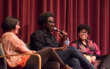 W. Kamau Bell with his wife (left) Melissa Hudson Bell 01 and assistant professor Danielle Morgan on stage at Mayer Theatre.