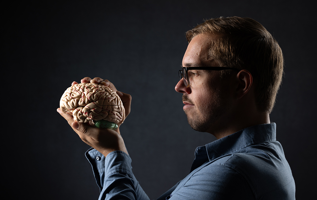 Soren Madsen holding model of brain