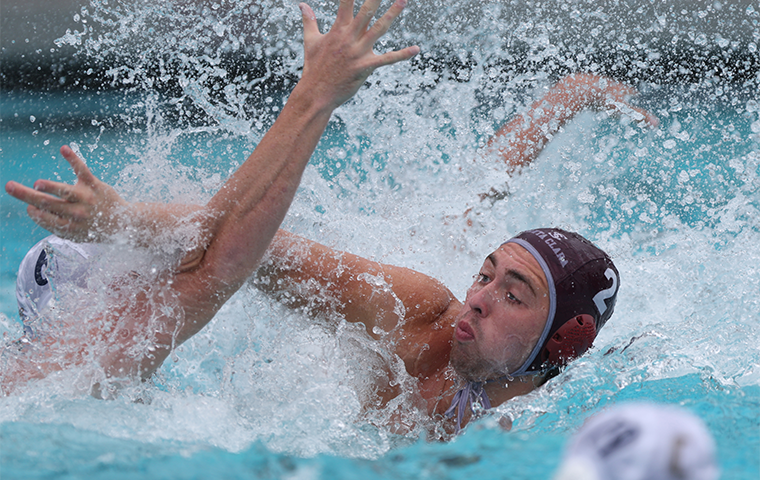 Photo of SCU water polo player Cody Ferguson on defense in the pool.