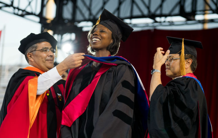 Student receiving her graduate diploma
