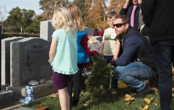 Chad Greer visits his father’s grave site during the Wreaths Across America ceremony in Los Gatos.
