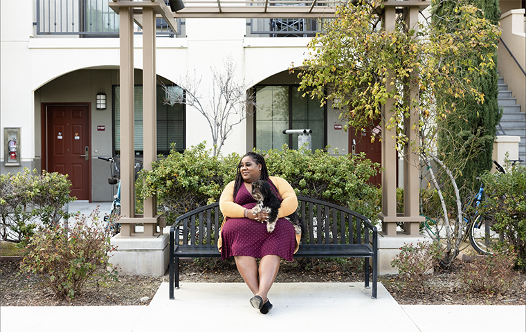 Photo of SCU Therapist in Residence Kristin Tappan '11, M.A. '17, in the courtyard of University Villas.