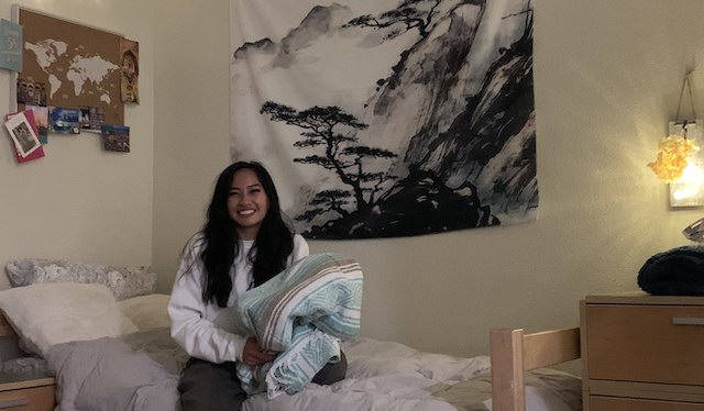 Isabel Andaya '24 holds a favorite blanket  inside her room at Graham Hall.