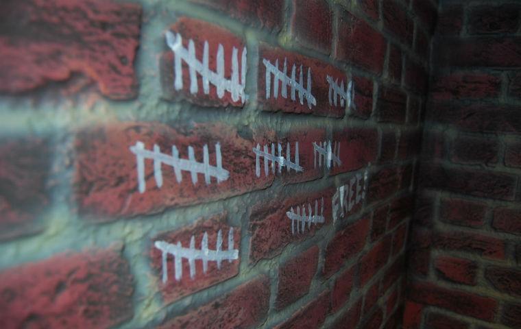 Image of jail cell hash marks image link to story
