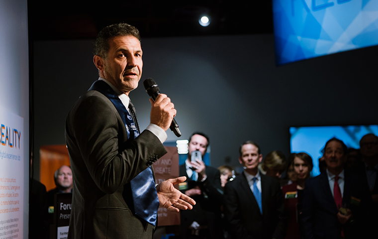 Khaled Hosseini ’88 talking to a crowd with a microphone image link to story