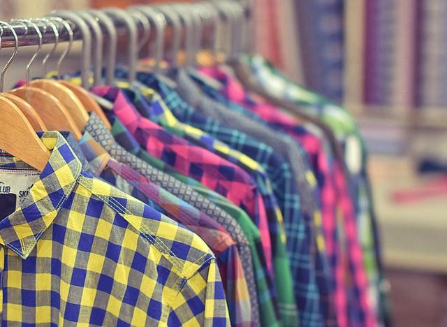 Photo of a rack of colorful men's plaid shirts.