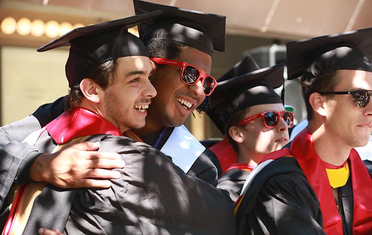 Two students hugging during Commencement 2021