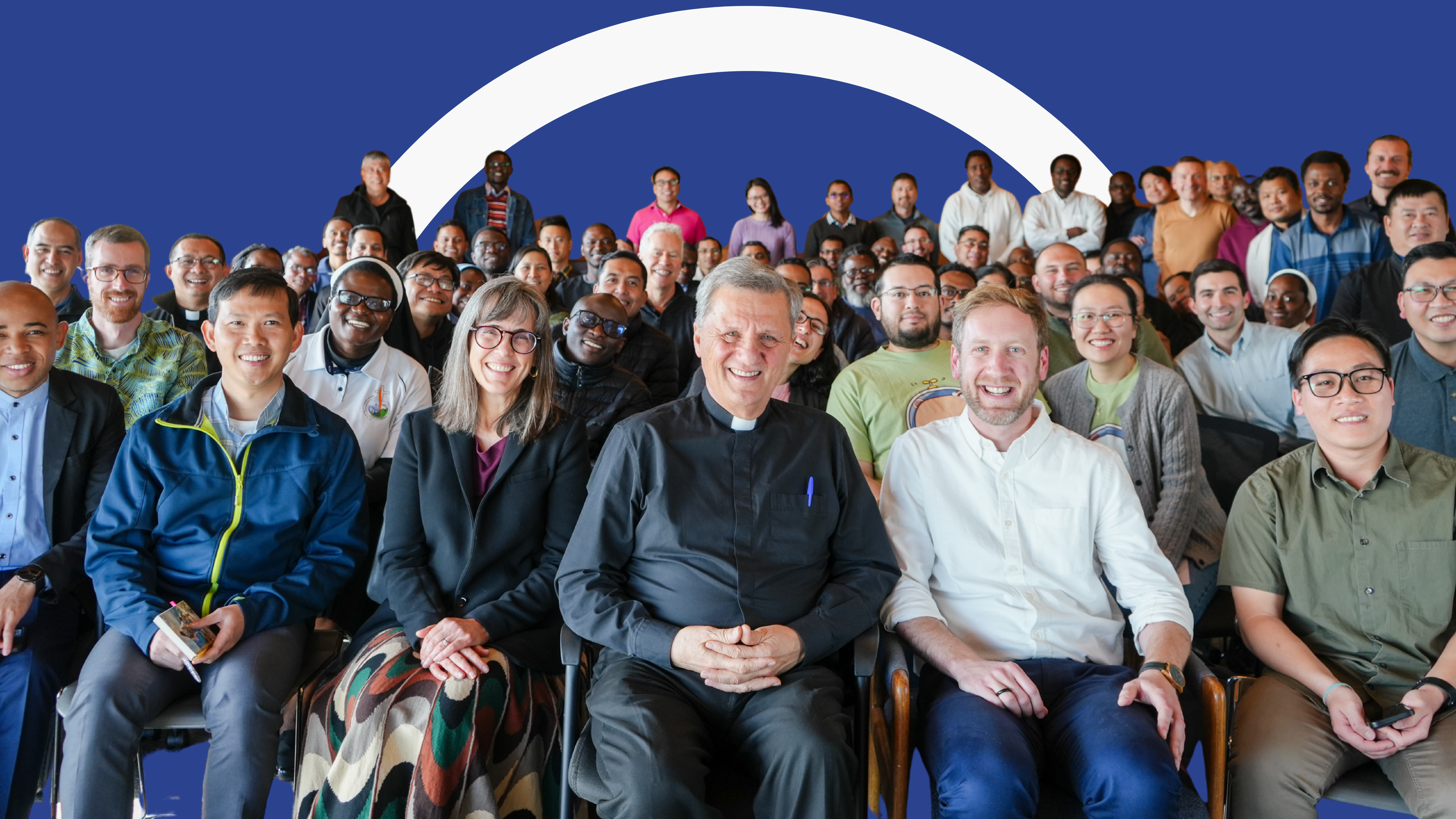 Large group of people looking at camera and smiling