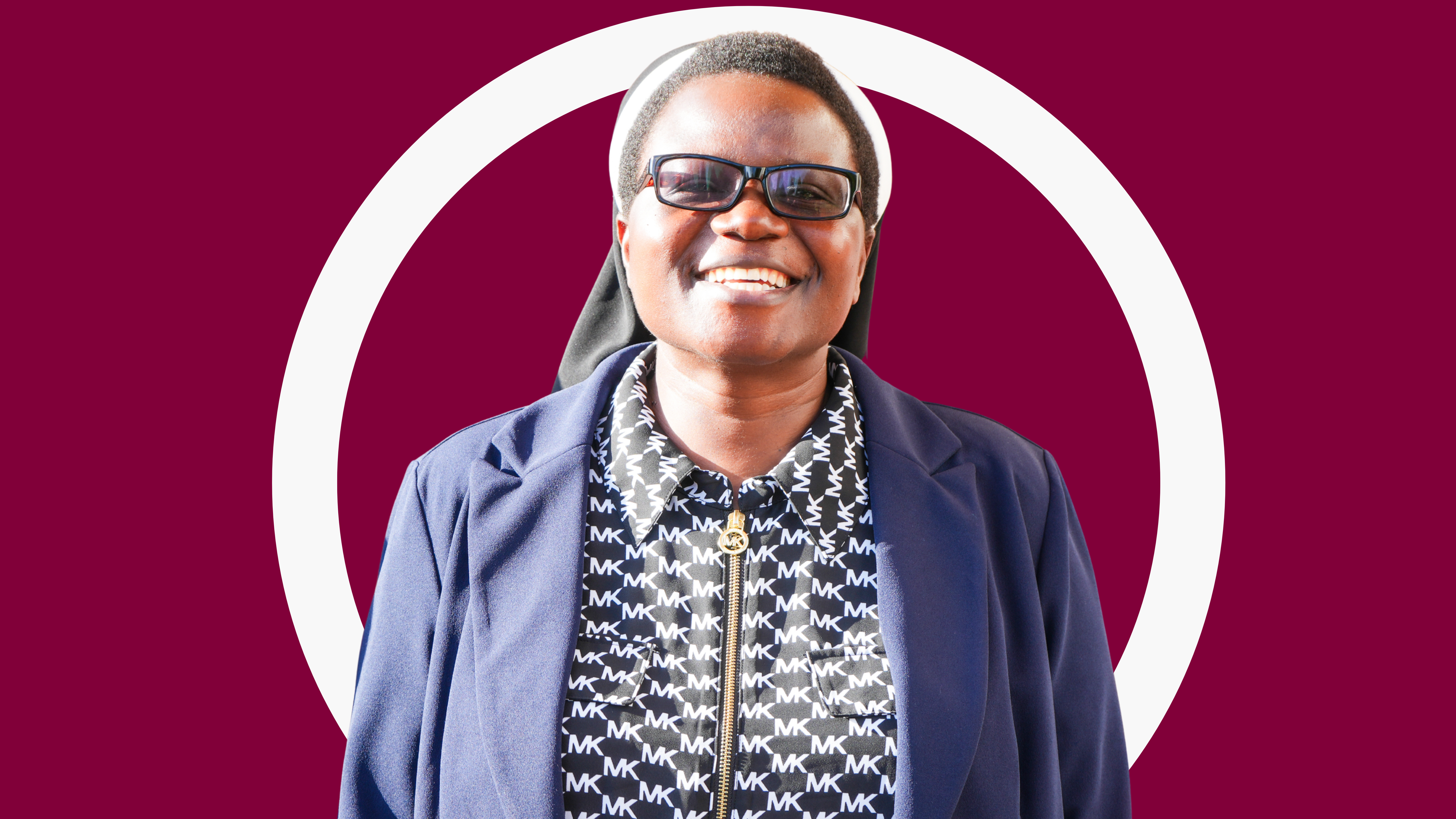 Woman with glasses looking at camera and smiling