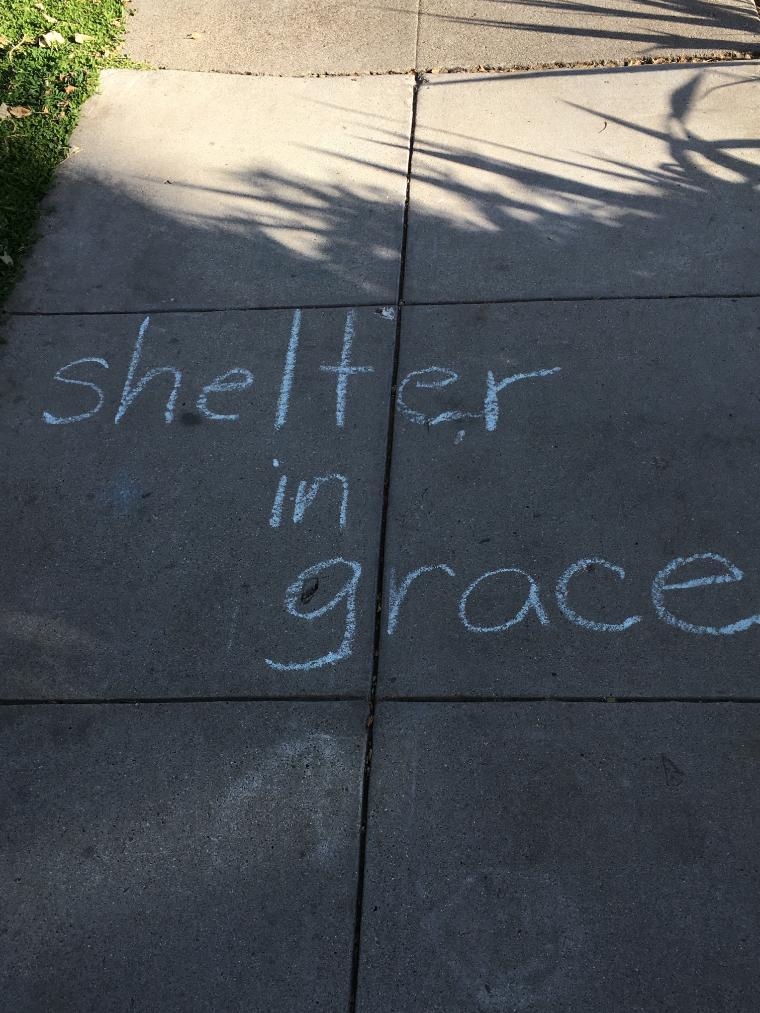 chalk on sidewalk: Shelter in Grace