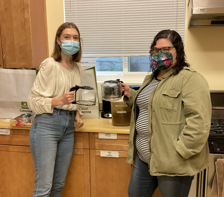 Two people in kitchen wearing masks during coffee training.