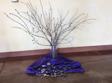 bare branch with rocks and purple cloth