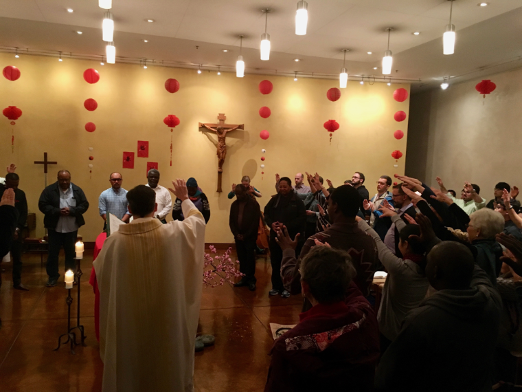 A religious gathering in a decorated hall, titled 