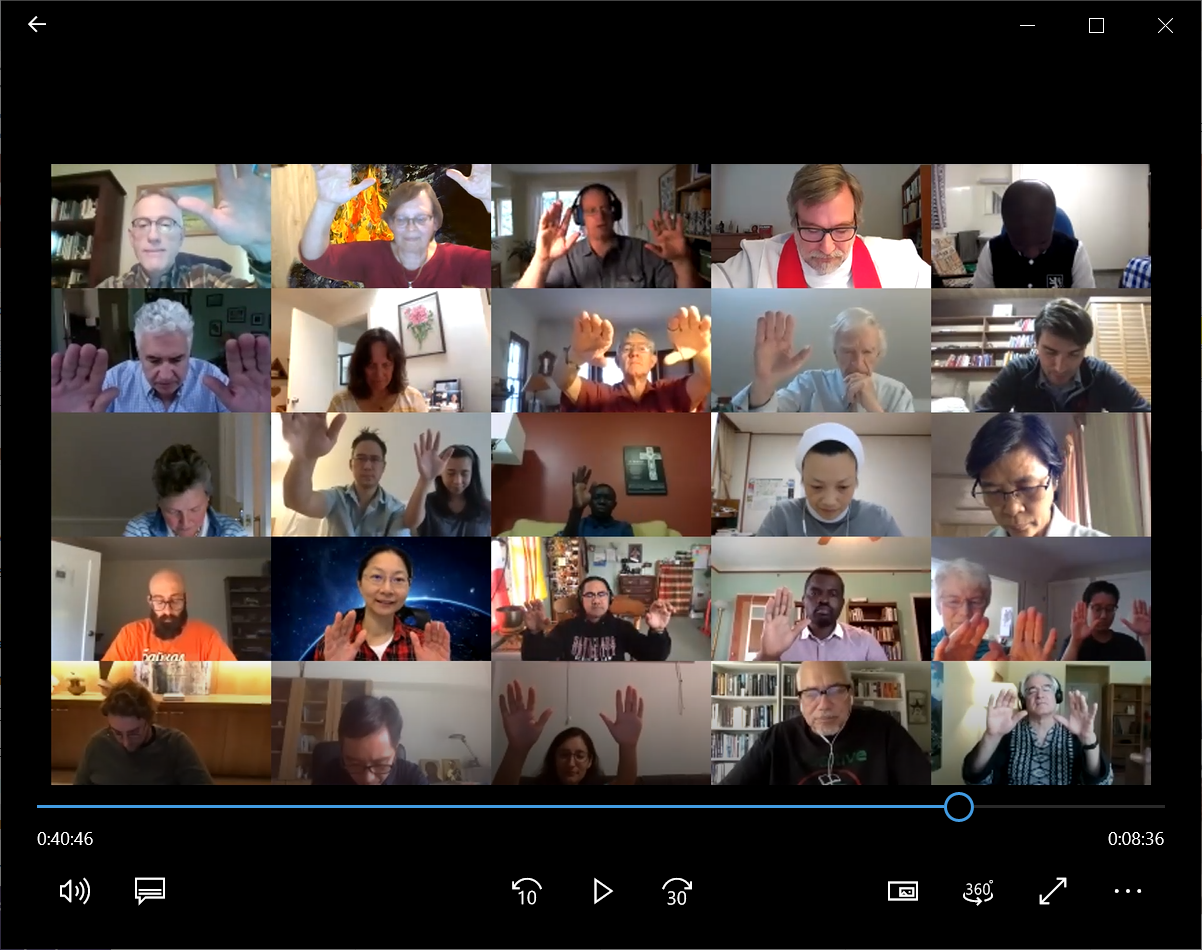 Screenshot of a virtual liturgy session with participants raising their hands in blessing.