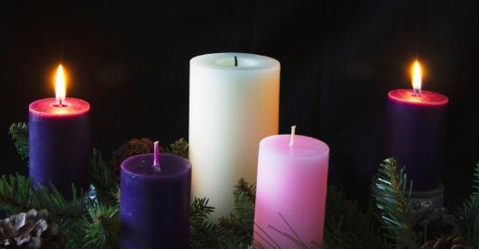 Two lit purple candles with white and pink candles. 'Second Sunday of Advent.'