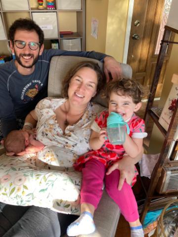 James smiling with his wife and two daughters