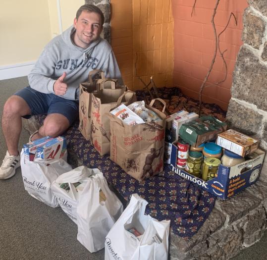 Tomi Korsa smiling with donations.