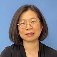 A person against a blue background.