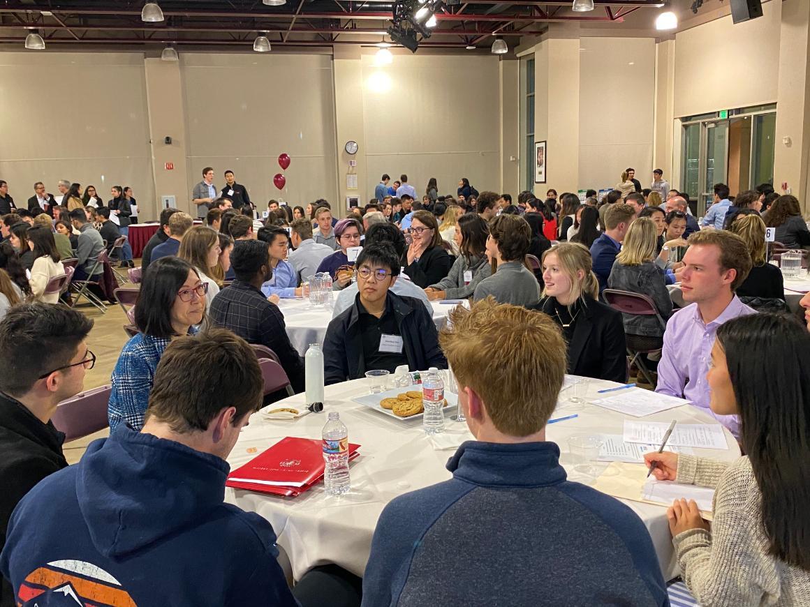 People engaged in a table discussion at ACTG Info Night 2020 event.