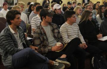 Students sitting and listening to speakers. image link to story