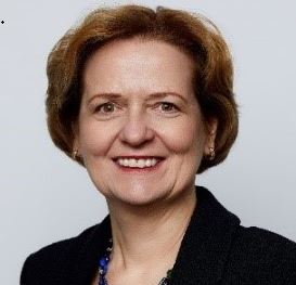 A woman smiling, titled Judy Bruner.