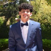 Troy Damu, SCU Accounting Association officer. Smile, curly hair, tuxedo.
