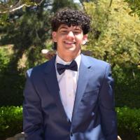 Troy Damu, SCU Accounting Association officer. Smile, curly hair, tuxedo.