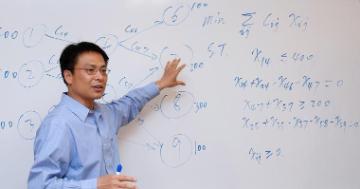 Professor instructing in front of whiteboard image link to story