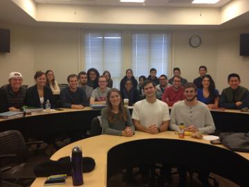 A group of people sitting in a conference room.