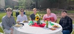 Five people sitting at a table with 