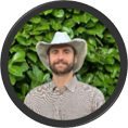 Ian McCluskey smiling in cowboy hat