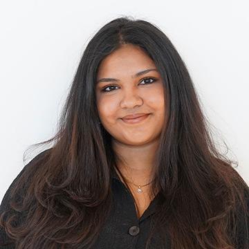 Woman with long hair and black top smiling