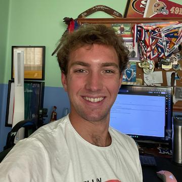 Man smiling in dorm room