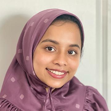 Woman with purple headscarf smiling