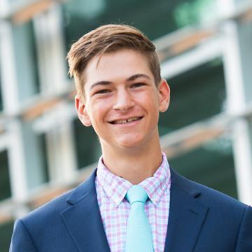 Man smiling in suit and tie