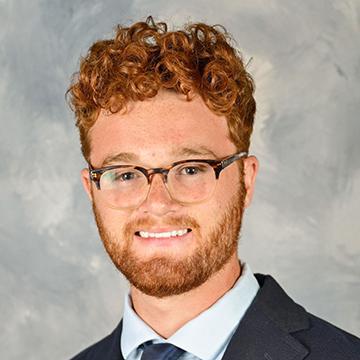 Man in suit and tie smiling