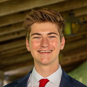 Man smiling in suit and tie