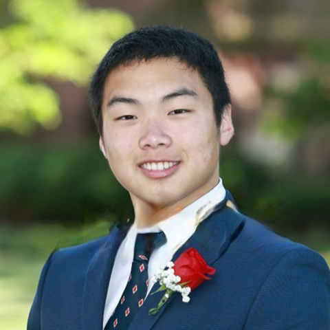 Man in suit and tie smiling