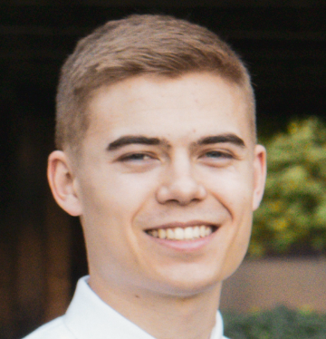 A person smiling outdoors.