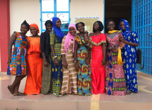 A group of women in colorful traditional attire standing together.