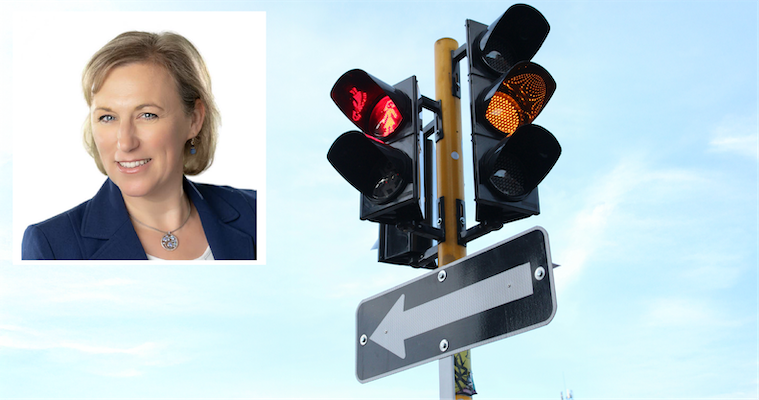 Anne Moser headshot over a photo of a stoplight