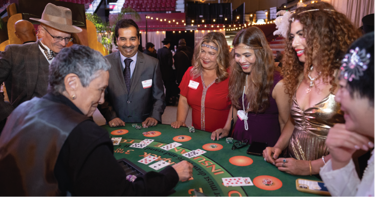 Centennial Gala attendees enjoying casino and other 1920s themed activities image link to story