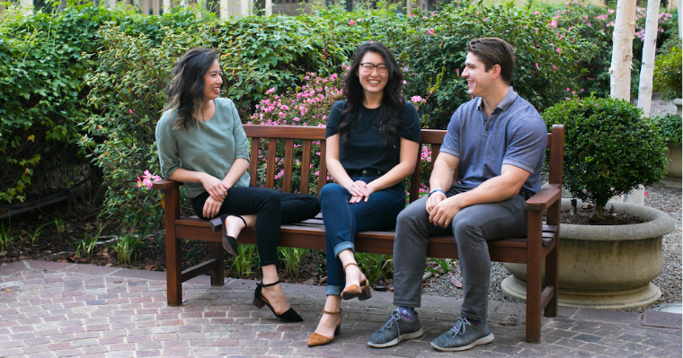 Garrett Jensen and two others sitting on a bench outdoors image link to story