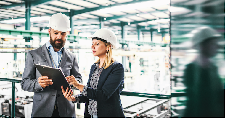 Man and woman discussing sustainability over a clipboard image link to story