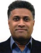 Man in a suit smiling.