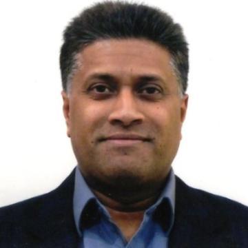 Man in a suit smiling.