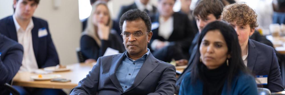 Panel judges listening intently to Leavey student international business case presentations