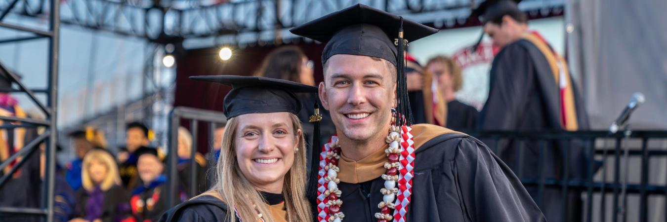 Leavey graduates celebrating their accomplishment at commencement of getting an MBA.