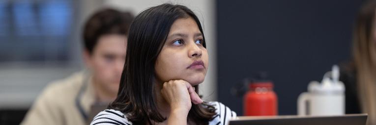 Leavey student with laptop focused in class